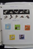 A collection of mint decimal GB stamps on album pages and in presentation packs, along with two