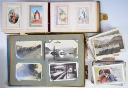 Early 20thC postcards, loose and in an album, including battleships, railway steam locomotives,