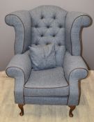Wing back armchair with button back and cushion, raised on cabriole legs, recently upholstered in