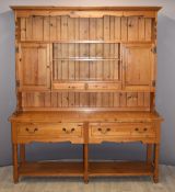 Pine dresser with twin cupboards, two drawers and undershelf, W18 x D47 x H210cm, the base 80cm