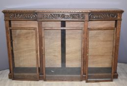 Oak breakfront bookcase with carved decoration, W183 x D34 x H114cm