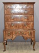 George I feather banded walnut chest on stand with out swept cornice above two over three