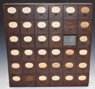 A collection of violin parts including bridges, strings, pegs etc, all stored in a wooden multi-