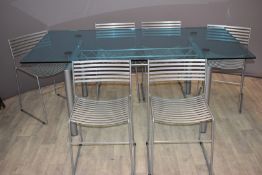 Designer glass dining table and six chairs with industrial gantry stretcher, raised on four circular