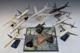 A collection of snap fit and diecast military and commercial model aircraft, all on display stands.