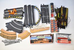 A collection of Scalextric model slot racing track and accessories including Humpback Bridge,