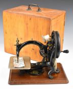 Late 19th or early 20thC Willcox & Gibbs sewing machine, in pine carry case with hinged handle to