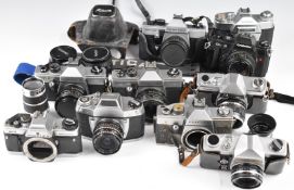 Eleven 35mm SLR cameras including Voigtlander Bessamatic with 1:2.8/50 and 1:4/135 lenses, Chinon