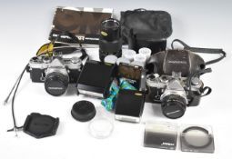 Two Olympus 35mm SLR cameras comprising Olympus OM1n with 50mm 1:1.8, 28mm 1:2.8 and 75-150 1:4