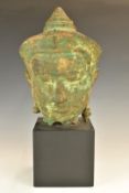 Archaic style cast metal bust on square plinth, possibly Thai or Burmese, height 46cm