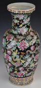 Chinese famille noir pedestal vase decorated with dragons amongst flowers, with seal mark to base,