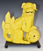 Chinese 19thC yellow glazed Dog of Fo figure, on wooden stand, height 27cm