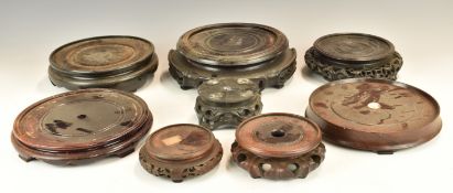 Eight Chinese 19th  / 20thC carved hardwood stands, tallest 7cm, maximum diameter 23cm