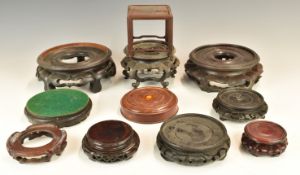 Eleven Chinese 19th / 20thC carved hardwood stands, tallest 9.5cm, maximum diameter 18cm