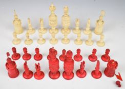 A carved bone chess set with one side stained red, height of king 13cm.