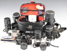 Two 35mm SLR cameras and accessories comprising Olympus OM10 35mm SLR camera with f=50mm 1:1.8 lens,