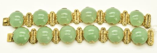A pair of silver gilt Chinese bracelets made up of embossed links depicting bats and jade