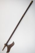 19th/20thC tribal axe, possibly Indian, with metal fittings, possibly once a pipe, length 91cm