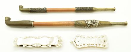 Two Japanese opium pipes together with two Chinese mother-of-pearl gaming counters or tokens, length