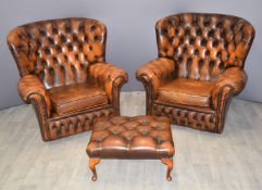 Pair of Chesterfield leather wingback armchairs and matching footstool