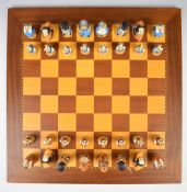 Studio Anne Carlton Alice in Wonderland chess set on wooden board, with related paperwork.