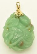 A 14k gold pendant set with carved quartz / jadeite depicting a pear and foliage, 27.9g, 4.7cm