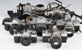 Seven 35mm SLR cameras comprising Canon A-1 program with 50mm 1:1.8 lens, Olympus OM20 body,