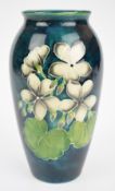 Moorcroft vase decorated with geraniums against a green ground, height 19cm