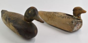 Two 19th/20thC carved wood duck decoys, largest height 14cm, length 42cm