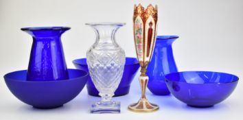 Seven pieces of clear and coloured glassware comprising an overlaid vase with gilt and floral enamel