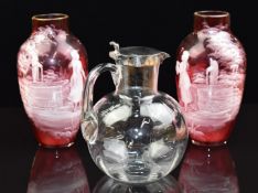 A pair of Victorian Mary Gregory cranberry glass vases and a Hukin & Heath whisky jug with silver