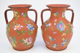 Pair of Wedgwood twin handled vases with enamelled flower decoration, height 20.5cm