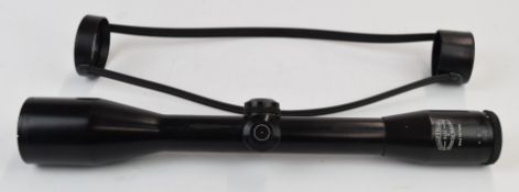 Schmidt & Bender 6x42 rifle scope with lens covers.