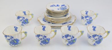 Nineteen pieces of bone china teaware with flower handles and Forget Me Not decoration