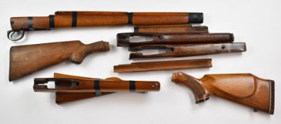 A collection of mainly Enfield rifle stocks and woodwork including military examples.