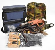 A collection of shooting accessories including cartridge bags and belts, rifle slings, butt recoil
