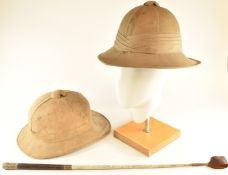 British Army Wolseley helmet and pith helmet together with a swagger stick for the 12th Lancers