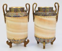 Pair of continental twin handled vases raised on ornate feet, possibly Zsolnay Pecs, height 28cm