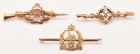 Three 9ct gold sweetheart brooches / tie pins comprising Royal Artillery, East Lancashire Regiment