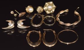 A pair of 9ct gold earrings (0.9g), a pair of yellow metal earrings set with a diamond (2.3g) and