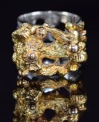 A 1970s 18ct tri-coloured gold ring with textured and abstract design, London 1971, maker SGC, 23.
