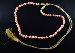 A necklace of coral and ridged gold beads