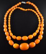 Two necklaces of graduated amber beads