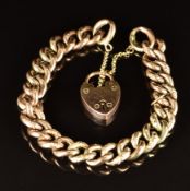 A 9ct gold curb link bracelet with engraved links and heart padlock clasp, 19cm, 17.3g