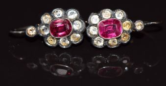 A pair of gold and silver earrings set with synthetic rubies and paste