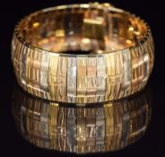 An 18k gold tri-coloured bracelet made up of textured links with rectangular decoration, 55.7g