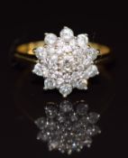 An 18ct gold ring set with diamonds in a cluster, 4.6g, size M