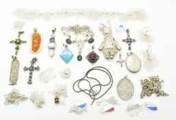 Twenty silver chains/ pendants including crosses, pressed amber, locket, etc