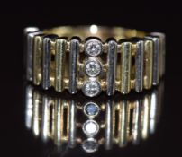 A 14k gold bi-coloured ring set with three diamonds, 9.7g, size T