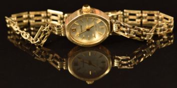 Accurist 9ct gold ladies wristwatch with gold hands and hour markers, silver dial and quartz